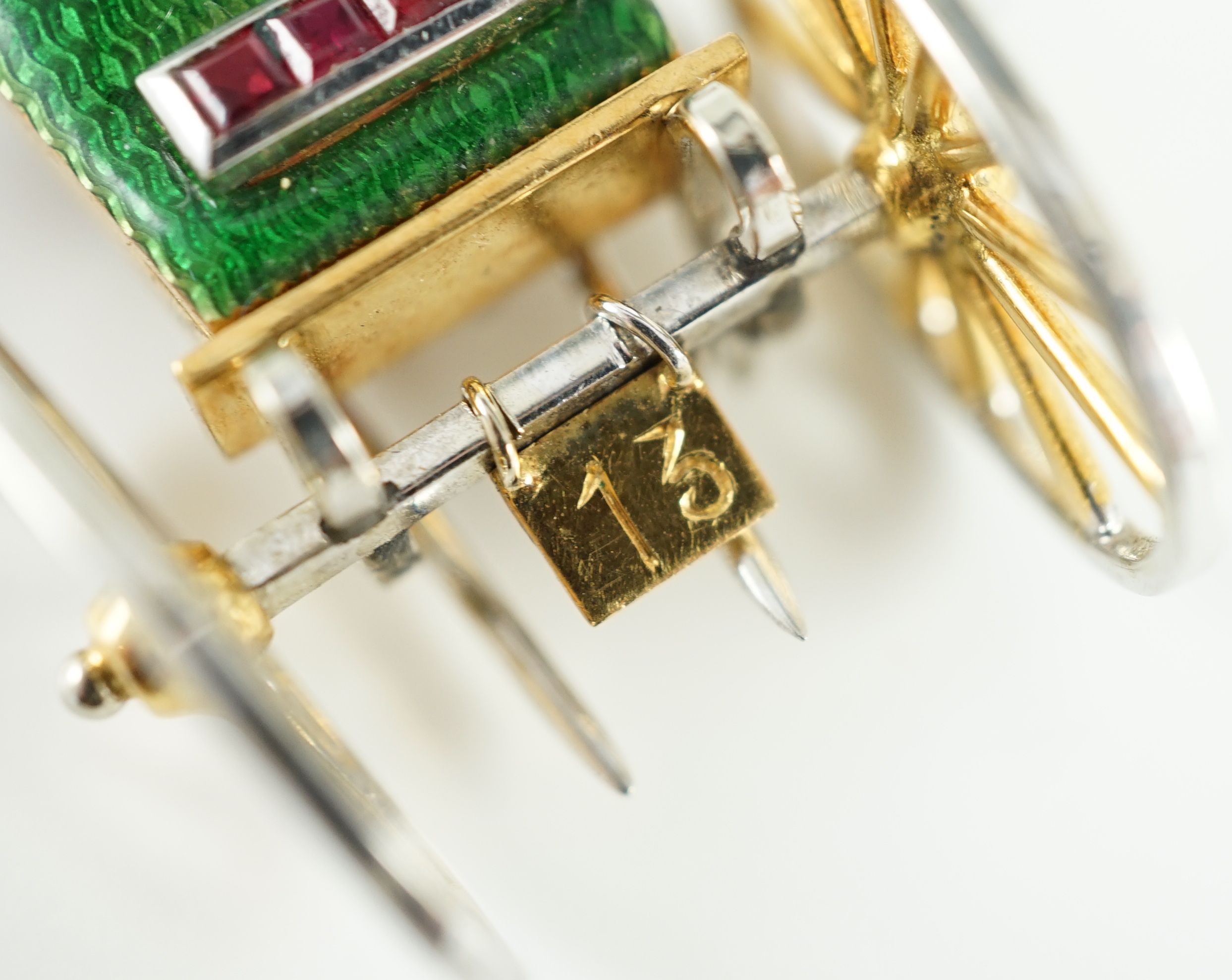 A mid 20th century Italian two colour 18ct gold, green enamel, ruby and diamond set novelty clip brooch, modelled as the rear view of a carriage with driver
